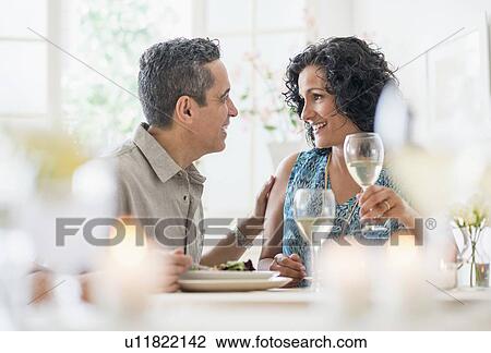 Stock Image - Couple dining in restaurant. Fotosearch