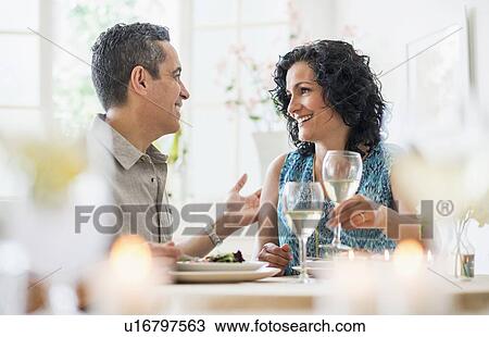 Stock Image - Couple dining in restaurant. Fotosearch