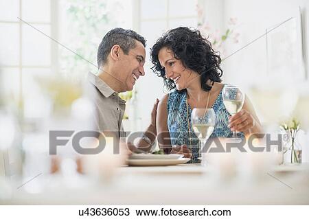 Stock Image - Couple dining in restaurant. Fotosearch