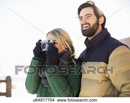 Couple photographing winter landscape View Large Photo Image Picture - Couple photographing winter landscape. Fotosearch