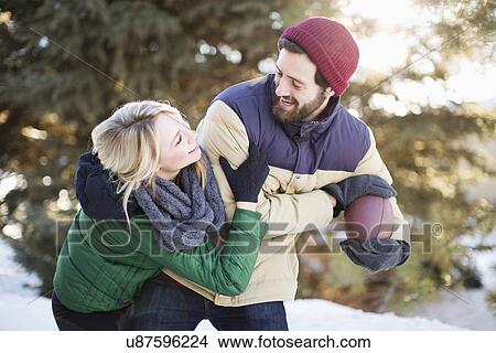 Picture - Couple playing American football. Fotosearch