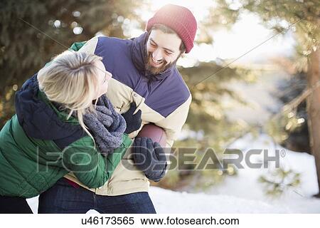 Stock Photography - Couple playing American football. Fotosearch