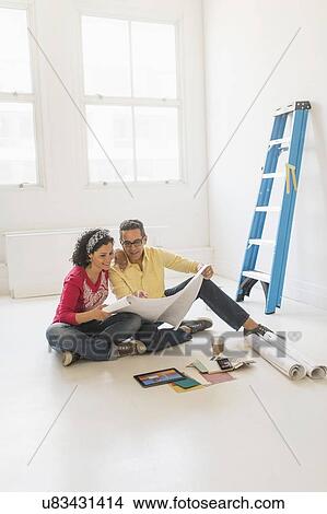 Couple preparing for renovation of new home View Large Photo Image Picture - Couple preparing for renovation of new home. Fotosearch