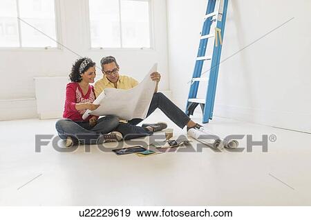 Couple preparing for renovation of new home View Large Photo Image Stock Photo - Couple preparing for renovation of new home. Fotosearch