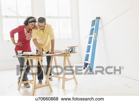 Couple preparing for renovation of new home View Large Photo Image Stock Photo - Couple preparing for renovation of new home. Fotosearch