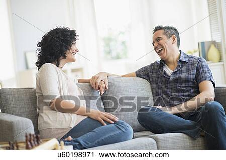 Couple talking on sofa View Large Photo Image Stock Image - Couple talking on sofa. Fotosearch