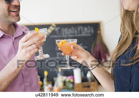 Couple toasting at party View Large Photo Image Stock Photo - Couple toasting at party. Fotosearch