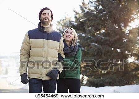 Couple walking in winter landscape View Large Photo Image Stock Photo - Couple walking in winter landscape. Fotosearch