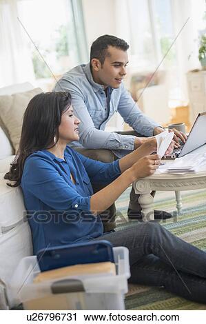 Couple working in living room View Large Photo Image Stock Image - Couple working in living room. Fotosearch