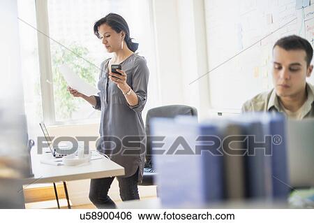 Couple working in office View Large Photo Image Stock Photograph - Couple working in office. Fotosearch