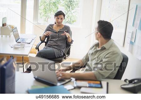 Couple working in office View Large Photo Image Stock Photography - Couple working in office. Fotosearch