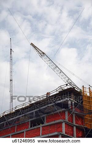 Stock Photography - Cranes against cloudy sky. Fotosearch