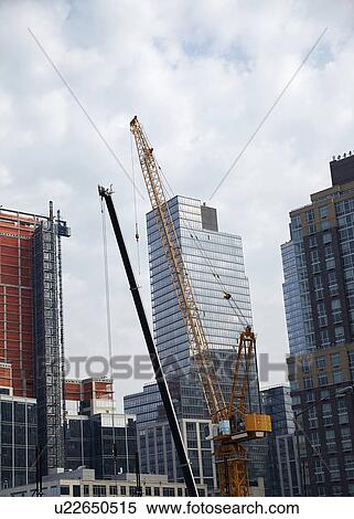 Cranes in urban scene View Large Photo Image Stock Photography - Cranes in urban scene. Fotosearch