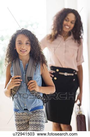 Stock Image - Daughter (8-9) and mother going to school. Fotosearch