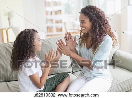Daughter (8-9) and mother playing clapping game View Large Photo Image Stock Image - Daughter (8-9) and mother playing clapping game . Fotosearch