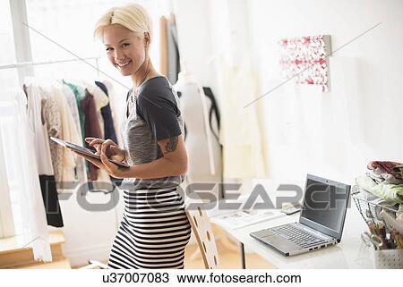 Stock Image - Designer using digital tablet in studio. Fotosearch