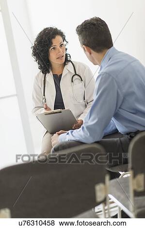 Doctor talking to patient View Large Photo Image Stock Photo - Doctor talking to patient. Fotosearch