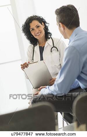 Stock Photo - Doctor talking with patient. Fotosearch