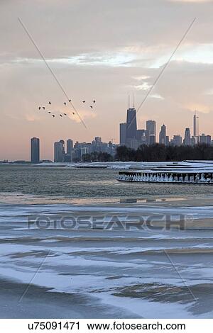 Stock Image - Downtown seen from north side at sunset. Fotosearch