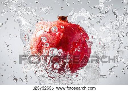 Droplets splashing on pomegranate View Large Photo Image Stock Photography - Droplets splashing on pomegranate. Fotosearch