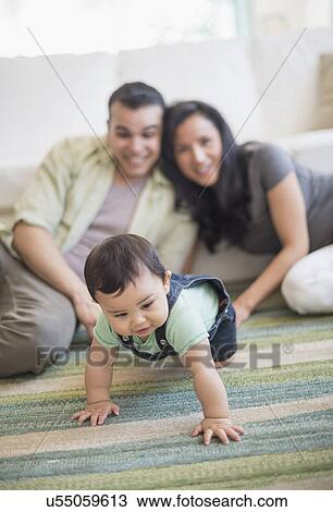Family with baby son (6-11 months) in living room View Large Photo Image Stock Image - Family with baby son (6-11 months) in living room. Fotosearch