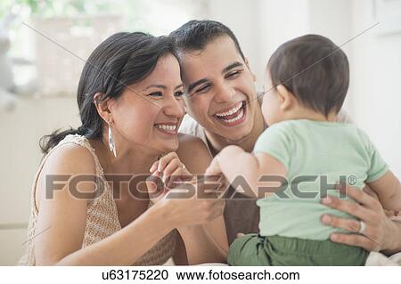 Family with baby son (6-11 months) in bedroom View Large Photo Image Stock Image - Family with baby son (6-11 months) in bedroom. Fotosearch