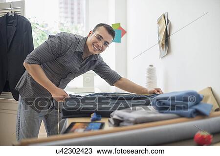 Fashion designer measuring vest View Large Photo Image Stock Image - Fashion designer measuring vest. Fotosearch