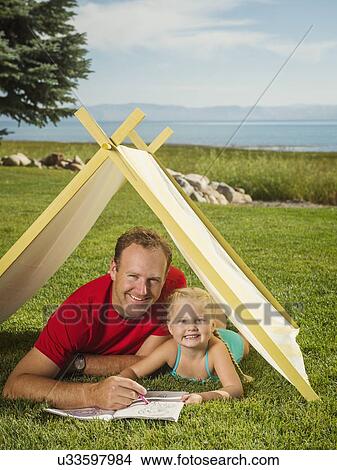 Picture - Father and daughter (2-3) playing in tent. Fotosearch