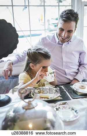Father and daughter (4-5) eating together in dining room View Large Photo Image Stock Photograph - Father and daughter (4-5) eating together in dining room. Fotosearch