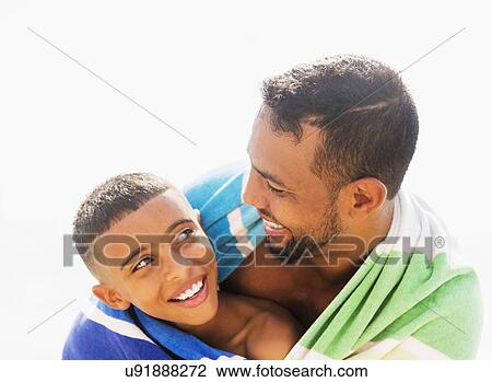 Father and son (10-11) embracing on beach View Large Photo Image Stock Image - Father and son (10-11) embracing on beach. Fotosearch