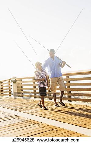 Father and son (10-11) fishing View Large Photo Image Stock Photo - Father and son (10-11) fishing. Fotosearch