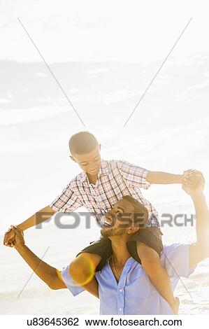 Father and son (10-11) having fun View Large Photo Image Stock Image - Father and son (10-11) having fun. Fotosearch
