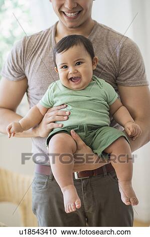 Father holding his son (6-11 months) View Large Photo Image Stock Image - Father holding his son (6-11 months). Fotosearch