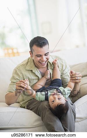 Father holding his son (6-11 months) View Large Photo Image Stock Image - Father holding his son (6-11 months). Fotosearch