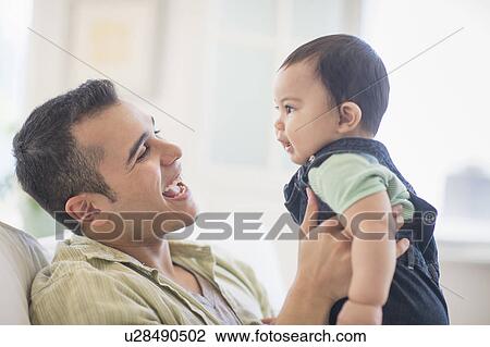 Stock Image - Father playing with his son (6-11 months). Fotosearch