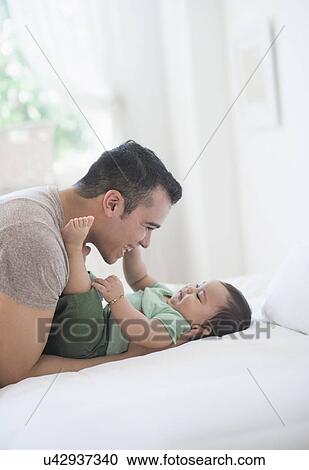 Father playing with his son (6-11 months) View Large Photo Image Stock Image - Father playing with his son (6-11 months). Fotosearch