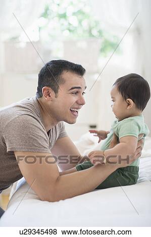 Father playing with his son (6-11 months) View Large Photo Image Stock Photo - Father playing with his son (6-11 months). Fotosearch
