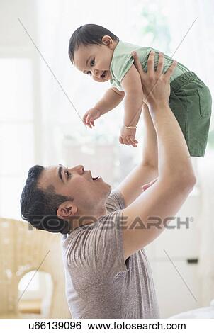 Father playing with his son (6-11 months) View Large Photo Image Stock Photograph - Father playing with his son (6-11 months). Fotosearch