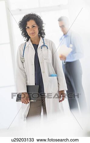 Stock Image - Female and male doctors in hospital. Fotosearch
