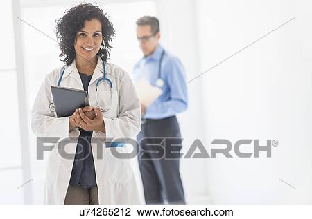 Stock Image - Female and male doctors in hospital. Fotosearch