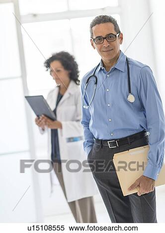 Stock Photography - Female and male doctors in hospital. Fotosearch