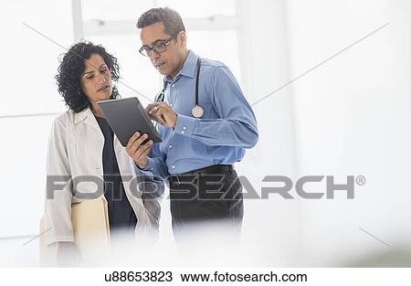 Female and male doctors working together View Large Photo Image Stock Image - Female and male doctors working together. Fotosearch