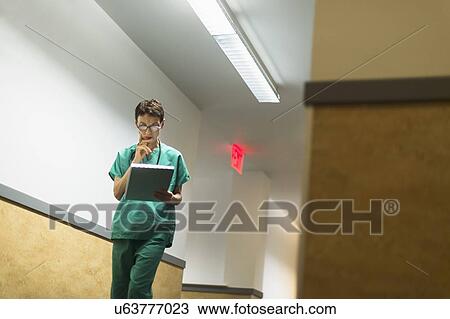 Female doctor in hospital corridor View Large Photo Image Stock Image - Female doctor in hospital corridor. Fotosearch