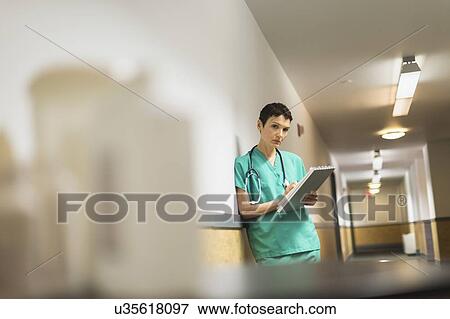 Female doctor in hospital corridor View Large Photo Image Stock Photo - Female doctor in hospital corridor. Fotosearch