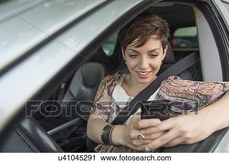 Female driver text messaging View Large Photo Image Stock Image - Female driver text messaging. Fotosearch