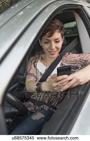 Female driver text messaging View Large Photo Image Stock Photography - Female driver text messaging. Fotosearch