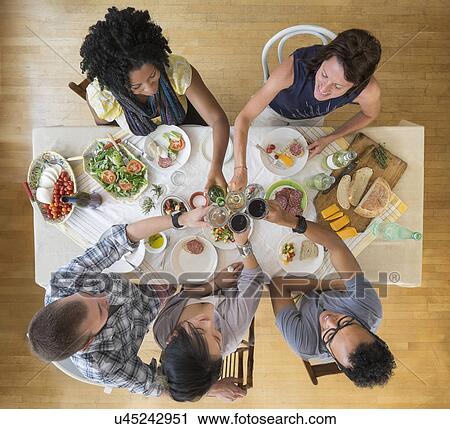 Stock Image - Friends having dinner together. Fotosearch