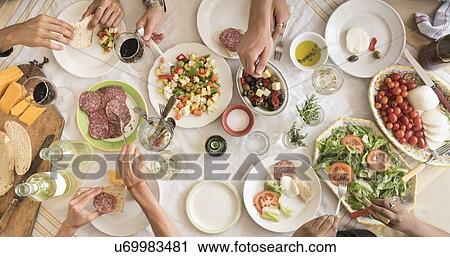 Stock Image - Friends having dinner together. Fotosearch