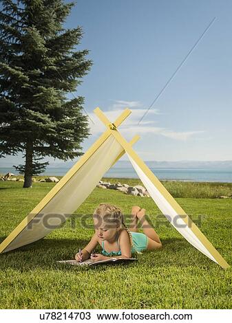 Stock Image - Girl (2-3) lying in tent. Fotosearch
