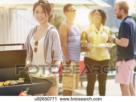 Group of friends enjoying barbeque View Large Photo Image Stock Image - Group of friends enjoying barbeque. Fotosearch